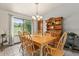 Bright dining room with wooden table, chairs, chandelier, and view of the outdoor space at 8427 S Custer Ln, Evergreen, CO 80439