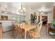 Open dining area featuring tile floors, wooden furniture, and a view to the living room at 8427 S Custer Ln, Evergreen, CO 80439