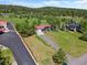 Charming single-story home with a red roof, a paved driveway, and lush green lawn at 8427 S Custer Ln, Evergreen, CO 80439