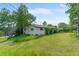 Charming home with a well-maintained lawn and mature trees creating a serene setting at 8427 S Custer Ln, Evergreen, CO 80439
