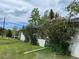 Home exterior showing large bushes, lawn and partial view of roof at 8427 S Custer Ln, Evergreen, CO 80439