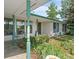Inviting front porch with decorative pillars and mature landscaping at 8427 S Custer Ln, Evergreen, CO 80439