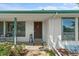 Close-up of the front porch featuring a decorative door, plants, and a cozy seating area at 8427 S Custer Ln, Evergreen, CO 80439