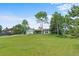 Landscaped front yard with a well-maintained lawn leading up to a ranch-style home with a two-car garage at 8427 S Custer Ln, Evergreen, CO 80439