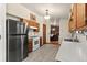 Well-lit kitchen with stainless steel appliances, tile floors, and view to the living area at 8427 S Custer Ln, Evergreen, CO 80439