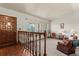 Bright living room with large windows, a cozy seating area, and hardwood floors at 8427 S Custer Ln, Evergreen, CO 80439