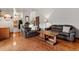 Spacious living room with hardwood floors, comfortable sofas, and ample natural light at 8427 S Custer Ln, Evergreen, CO 80439