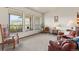 Open living room featuring large windows with views, comfortable seating, and bright interior at 8427 S Custer Ln, Evergreen, CO 80439
