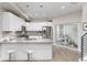 Bright eat-in kitchen featuring a modern island with barstool seating, and stainless steel appliances at 4551 Tennyson St, Denver, CO 80212