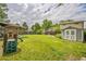 Expansive backyard with a playset, shed, and a sprawling lawn, perfect for outdoor activities at 8935 W Swarthmore Dr, Littleton, CO 80123