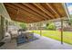 Covered patio area with outdoor seating, string lights, and a view of the fenced backyard at 8935 W Swarthmore Dr, Littleton, CO 80123