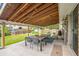 Inviting backyard patio featuring a dining set, string lights, and a well-maintained lawn with a playhouse at 8935 W Swarthmore Dr, Littleton, CO 80123