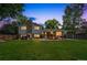 Expansive backyard with lush lawn, patio, playhouse, and privacy fence, ideal for outdoor living and entertaining at 8935 W Swarthmore Dr, Littleton, CO 80123