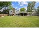 Spacious backyard features a large lawn, covered patio, and play set, great for outdoor enjoyment at 8935 W Swarthmore Dr, Littleton, CO 80123