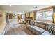 Comfortable basement with brick fireplace and seating, flooded with natural light from two large windows at 8935 W Swarthmore Dr, Littleton, CO 80123