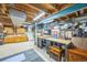 Spacious unfinished basement with exposed beams, ample storage, and a workbench area at 8935 W Swarthmore Dr, Littleton, CO 80123