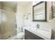 Bright bathroom with a glass-enclosed shower, vanity with a large mirror, and modern fixtures at 8935 W Swarthmore Dr, Littleton, CO 80123