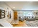 Inviting entryway with coat hooks, wood floors, and a view into the living room at 8935 W Swarthmore Dr, Littleton, CO 80123