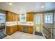 Kitchen features stainless steel appliances, ample wood cabinetry and window over sink at 8935 W Swarthmore Dr, Littleton, CO 80123