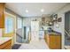 Spacious kitchen area with pantry, stairway access, and breakfast bar area at 8935 W Swarthmore Dr, Littleton, CO 80123