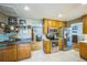Well-lit kitchen features stainless steel appliances, wooden cabinets, and floating shelves at 8935 W Swarthmore Dr, Littleton, CO 80123