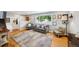 Bright living room featuring hardwood floors, a large window, and comfortable seating at 8935 W Swarthmore Dr, Littleton, CO 80123