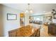 Open concept living space with wood floors, dining area, and kitchen view at 8935 W Swarthmore Dr, Littleton, CO 80123
