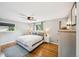 This main bedroom has hardwood floors, a ceiling fan, and two windows for natural light at 8935 W Swarthmore Dr, Littleton, CO 80123