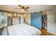 Spacious main bedroom boasts a barn door closet, wood floors, and en suite bathroom at 8935 W Swarthmore Dr, Littleton, CO 80123