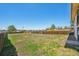 Large grassy backyard with wooden fence offering privacy and space for outdoor activities at 831 Sable Blvd, Aurora, CO 80011