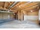 Unfinished basement with exposed ceiling beams and unfinished walls provides potential for customization at 831 Sable Blvd, Aurora, CO 80011
