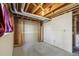Unfinished basement with a partially finished wall, offering a blank canvas for customization at 831 Sable Blvd, Aurora, CO 80011