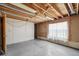 Unfinished basement featuring bright window and concrete floor, ready for renovation at 831 Sable Blvd, Aurora, CO 80011