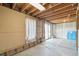 Unfinished basement featuring a sliding glass door to the outside and an exposed ceiling at 831 Sable Blvd, Aurora, CO 80011