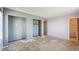 A bedroom with bare floors, two closets, and an open doorway to a bathroom at 831 Sable Blvd, Aurora, CO 80011
