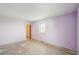 A bedroom with bare floors, a window providing natural light, and a doorway at 831 Sable Blvd, Aurora, CO 80011