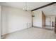 An empty dining room features laminate flooring, a chandelier and an attached accent wall at 831 Sable Blvd, Aurora, CO 80011