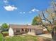 Charming one-story home with a well-maintained lawn and an attached one car garage at 831 Sable Blvd, Aurora, CO 80011