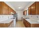 A kitchen featuring wood cabinets, white countertops, and standard appliances at 831 Sable Blvd, Aurora, CO 80011