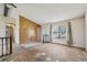 Bright living room with large window, wood-accented walls, and staircase leading to other parts of the home at 831 Sable Blvd, Aurora, CO 80011