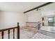 View of the living room with exposed ceiling beams, staircase, and open layout leading to the kitchen at 831 Sable Blvd, Aurora, CO 80011