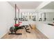 This bright basement includes workout equipment, a mirrored wall and a wood floor at 5575 Jackpine Rd, Evergreen, CO 80439