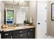 Well-lit bathroom with granite counters, vanity with storage, and combined tub/shower at 5575 Jackpine Rd, Evergreen, CO 80439