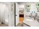 Neutral bathroom with subway tile shower, modern sink and vanity, and decorative touches at 5575 Jackpine Rd, Evergreen, CO 80439
