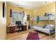 Bright bedroom with a bunk bed, large window, desk, and playful decor at 5575 Jackpine Rd, Evergreen, CO 80439