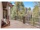 Spacious deck featuring an iron railing and views of the surrounding landscape at 5575 Jackpine Rd, Evergreen, CO 80439