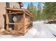 Attached enclosed pet kennel with snow covered exterior at 5575 Jackpine Rd, Evergreen, CO 80439