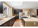 Bright kitchen features granite countertops, a center island and a view into the living room at 5575 Jackpine Rd, Evergreen, CO 80439