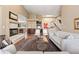 Spacious living room with fireplace, natural light, and seamless transition to other rooms at 5575 Jackpine Rd, Evergreen, CO 80439