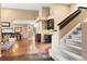 Spacious living room featuring hardwood floors, a staircase, and an adjoining dining area for seamless entertaining at 5575 Jackpine Rd, Evergreen, CO 80439